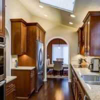 Wood Kitchen Cabinets and Gray Granite Countertop